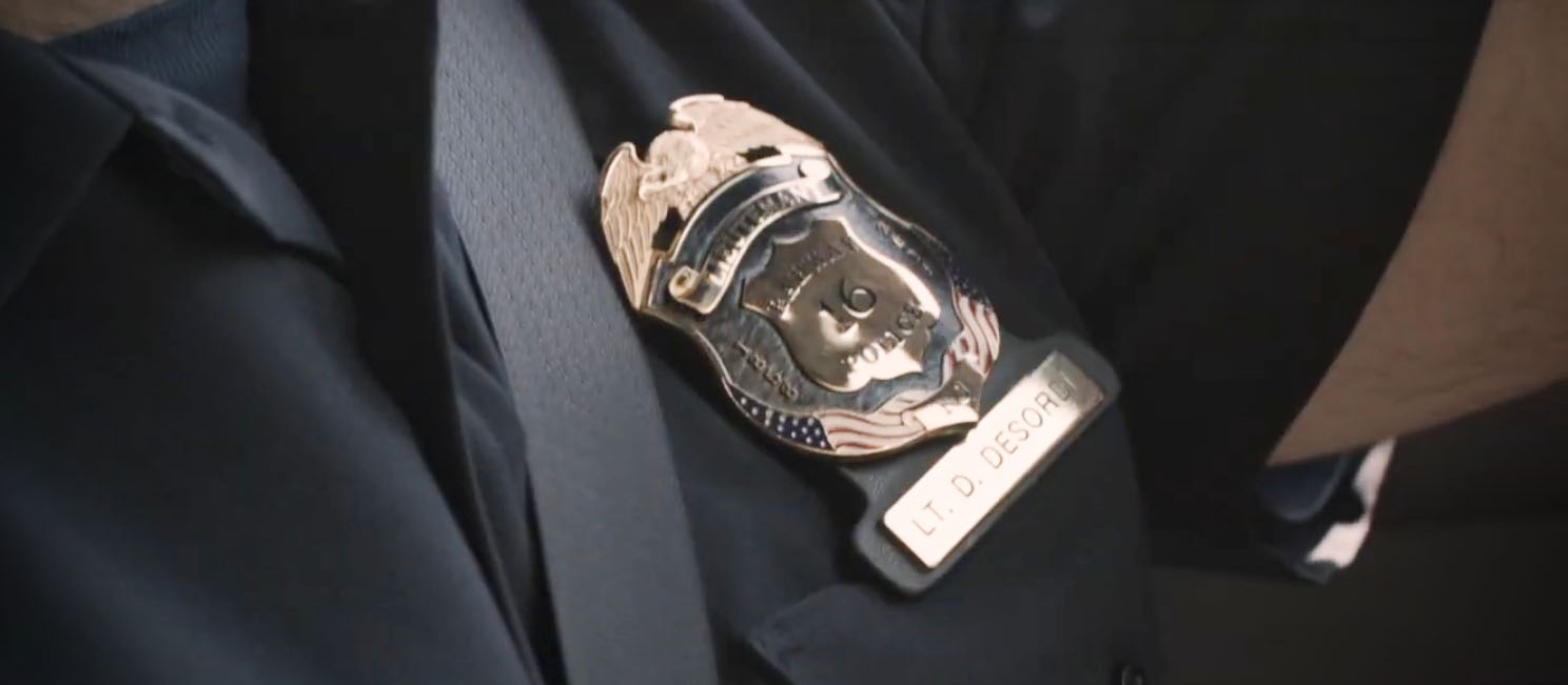 close up of a seat belt next to a police badge