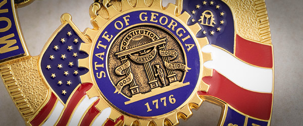 State of Georgia seal in the center of a badge
