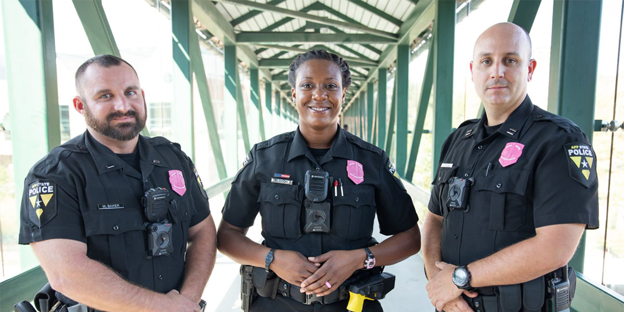Police officers wearing pink badges